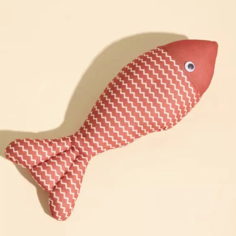 Fish-shaped catnip cat toy in blue with cat playing nearby, available in multiple sizes