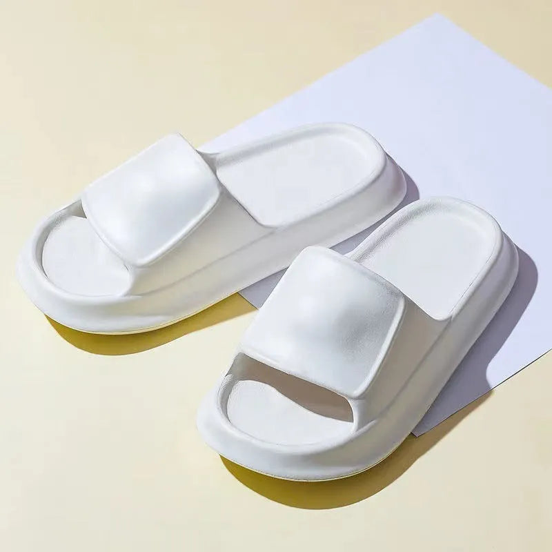 Pair of thick-soled EVA flip-flop slippers in a choice of seven colours, shown on a wet bathroom floor.