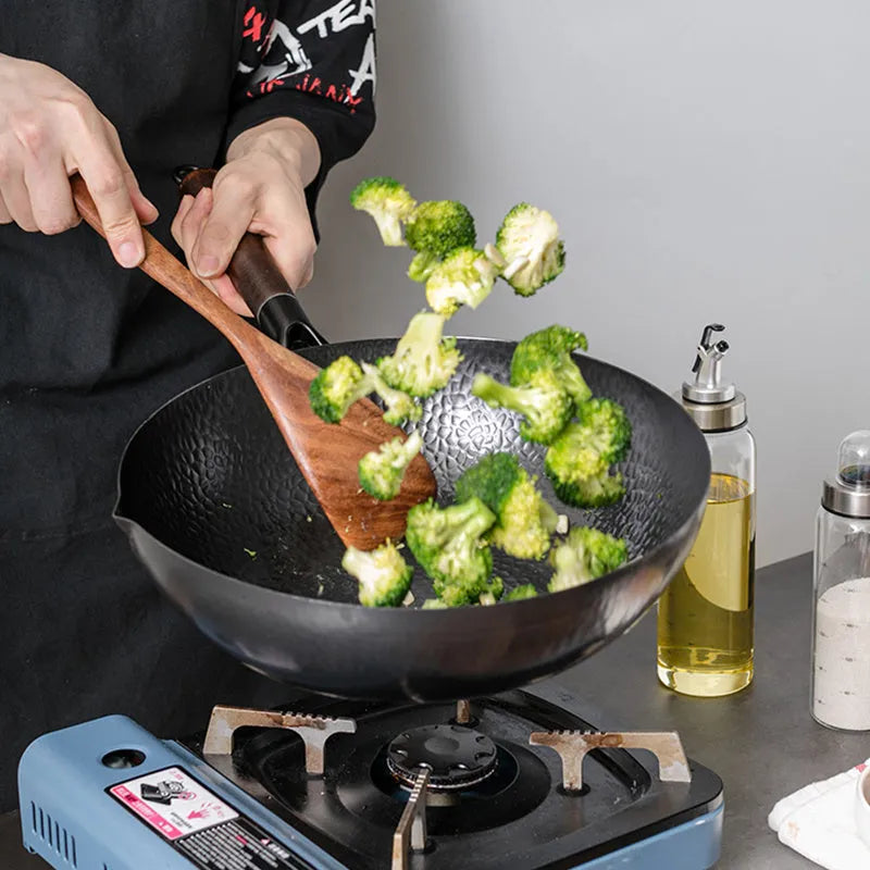 Black traditional iron wok pan with wooden handle, 32cm diameter with matching lid.