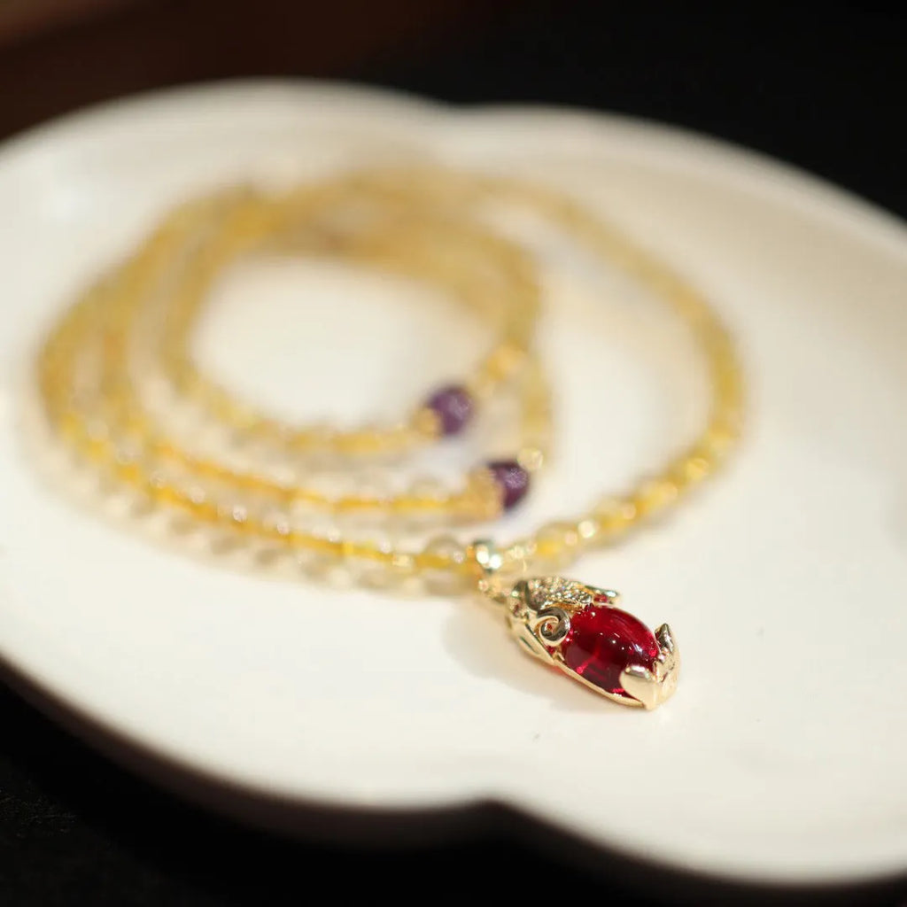 Natural gold rutilated quartz bracelet with three-circle gold and ruby bead design