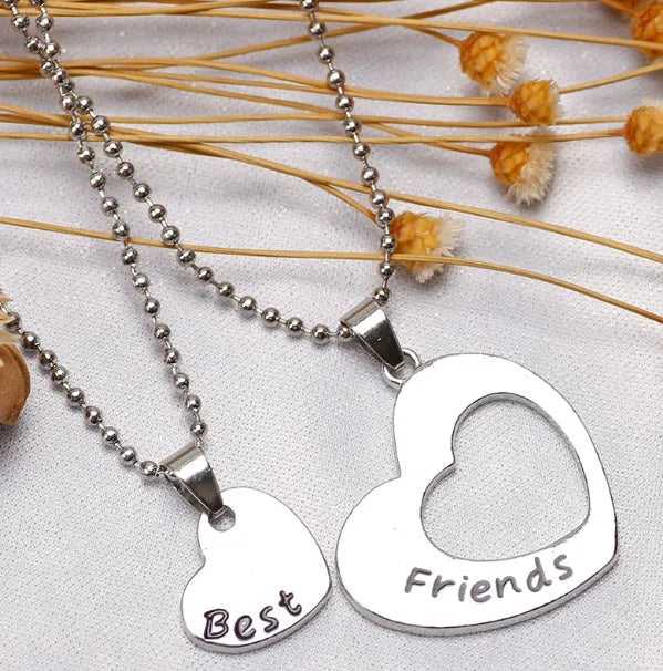 Two silver alloy heart-shaped puzzle necklaces on cross chains, matching set