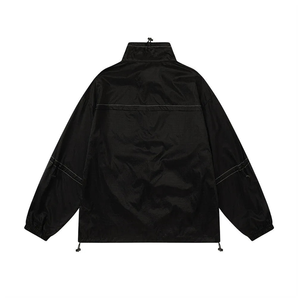 Men's thin loose sun protection jacket in black nylon fabric with pockets, worn casually outdoors