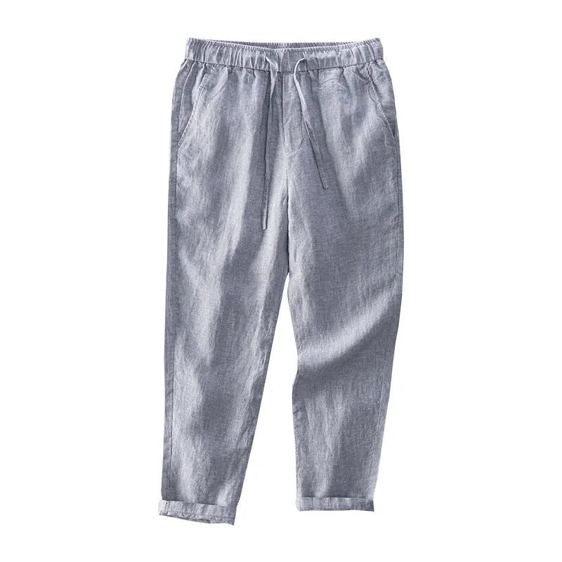 Men's straight-leg linen trousers in light gray shown laid flat.