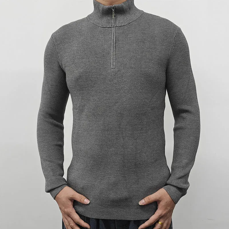 Man wearing a grey half turtleneck zip front sweater, a casual cotton blend pullover.