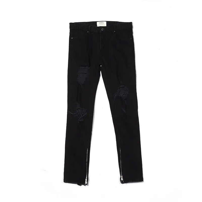 Men's high street style black torn jeans in washed black denim with raw edge details, front view.