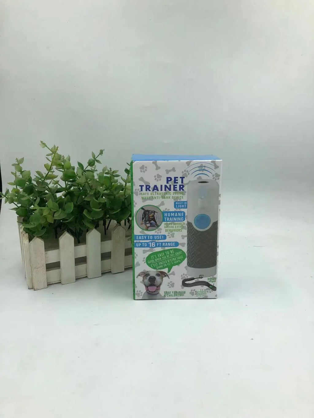 White ABS plastic handheld ultrasonic dog trainer device on a white background.