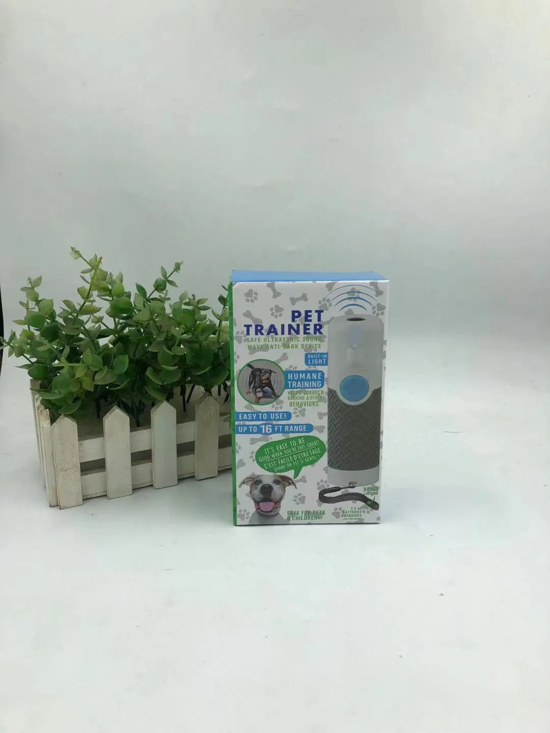 White ABS plastic handheld ultrasonic dog trainer device on a white background.