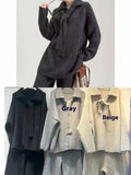 Acrylic fibre sweater suit two-piece set in beige, showing knitted top and casual trousers.