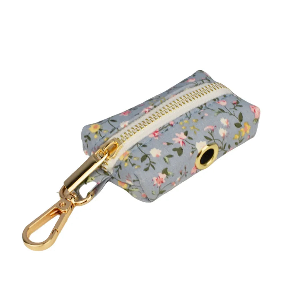 Blue floral patterned dog collar set with matching leash, bow, vest, and poop bag accessories