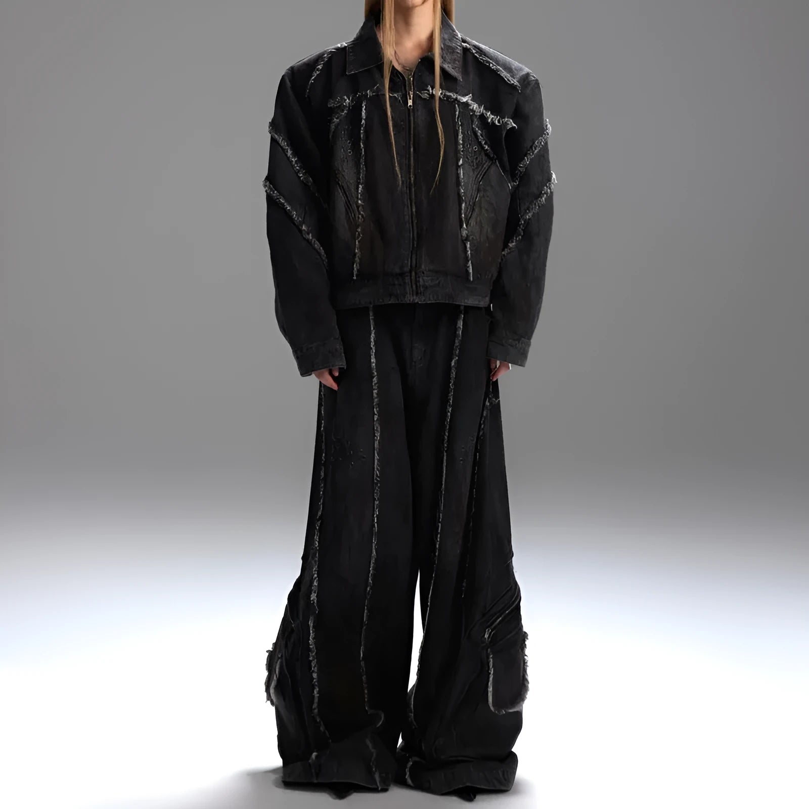 Black distressed denim coat and pants set with a gradient pattern and padded shoulders.