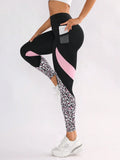 Women's black high waist yoga leggings with contrast patchwork leopard print design and side pocket