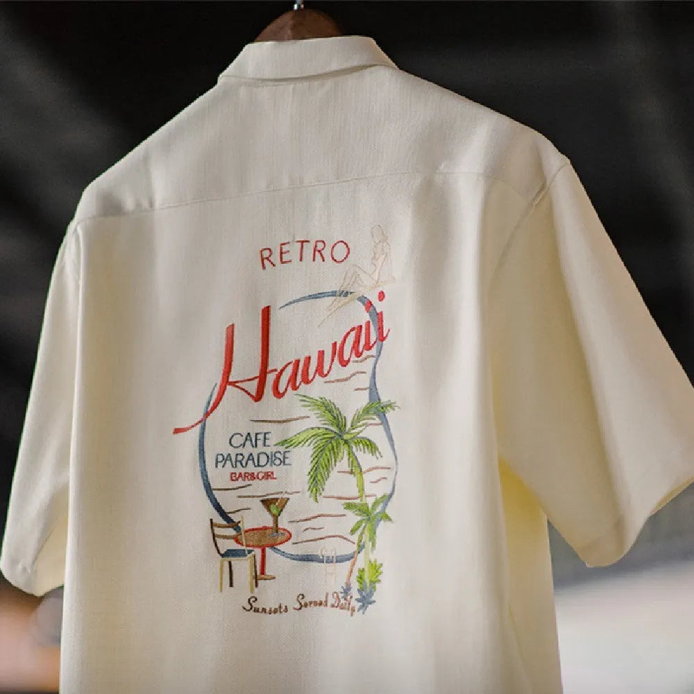 Light apricot men's Cuban collar shirt with bamboo and floral plant pattern.