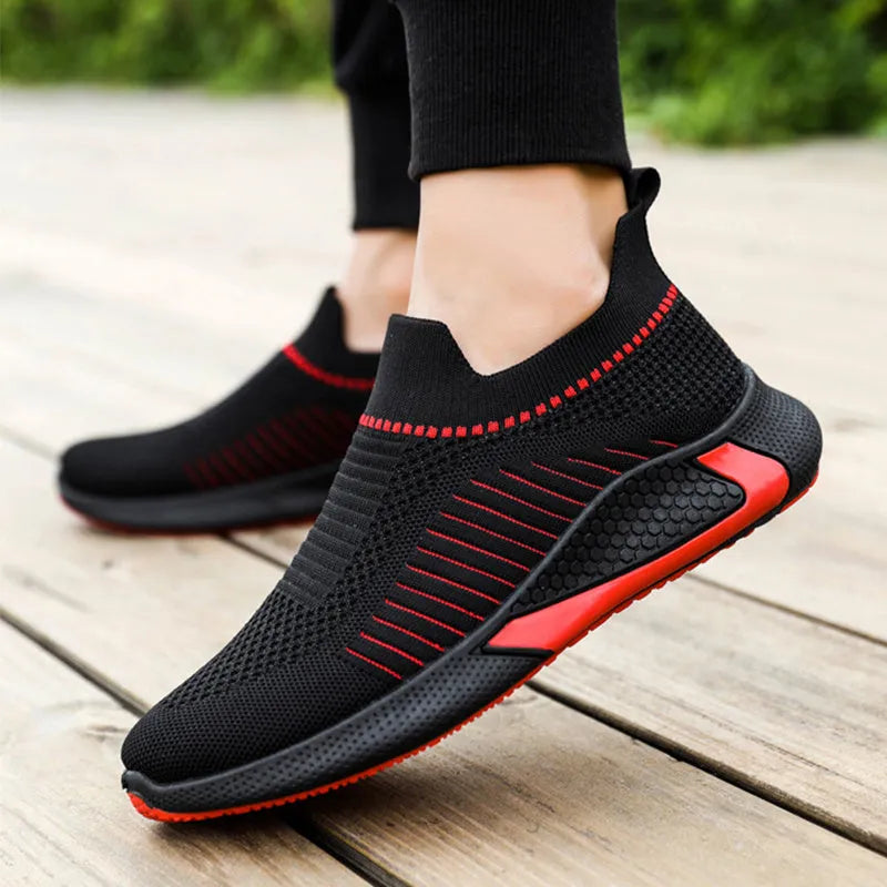 Men's black and white striped slip-on sneakers with lace-up front and mesh design.