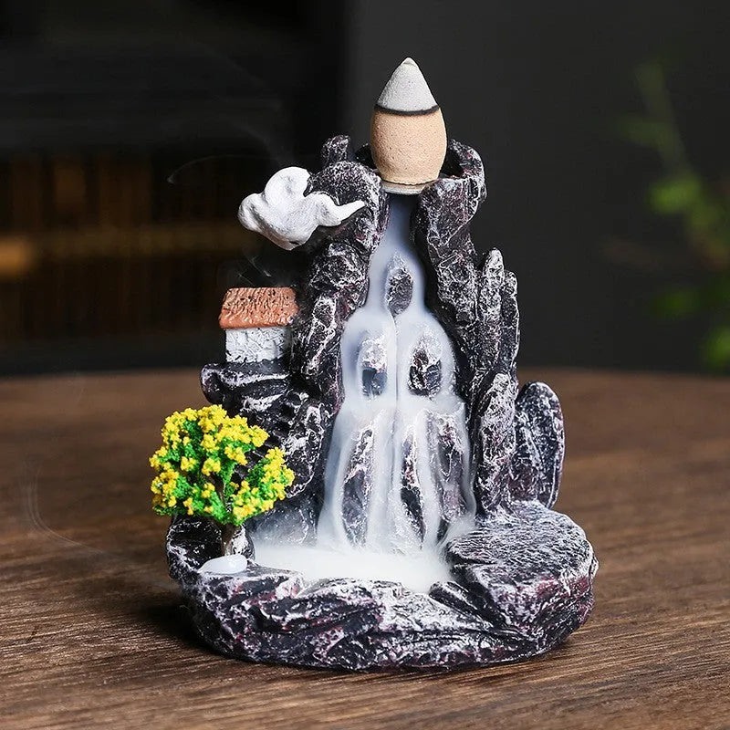 Ceramic backflow incense burner ornament in modern tree design on a table.