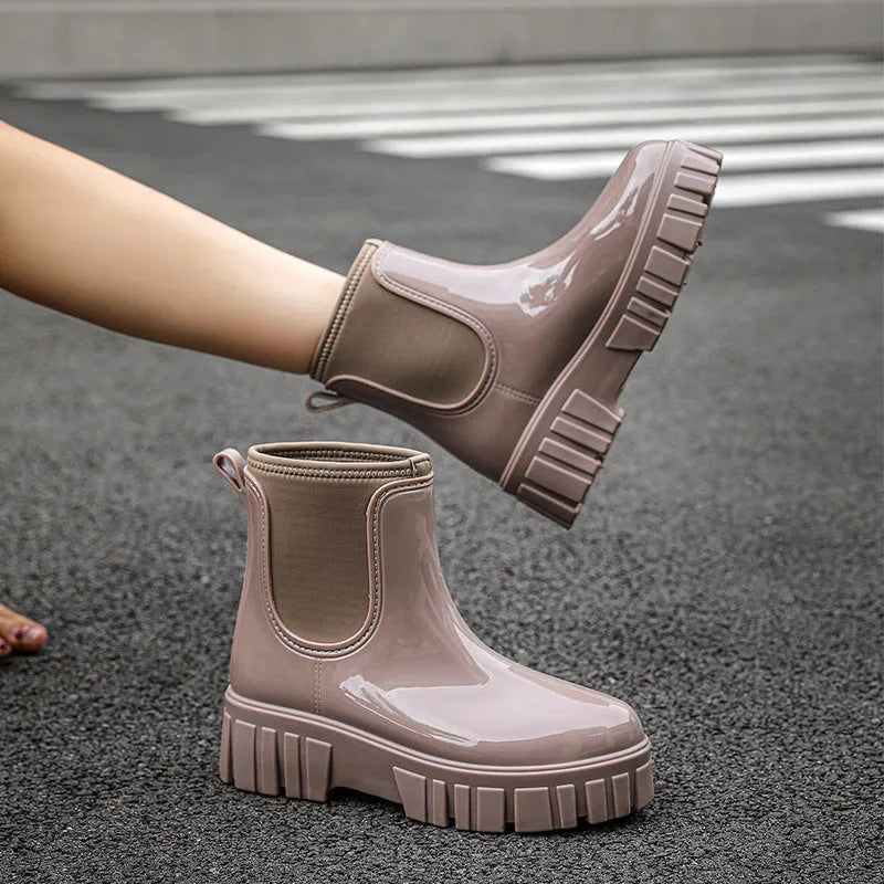 A pair of low tube PVC rain boots with a flat heel, shown in a solid colour on a white background.