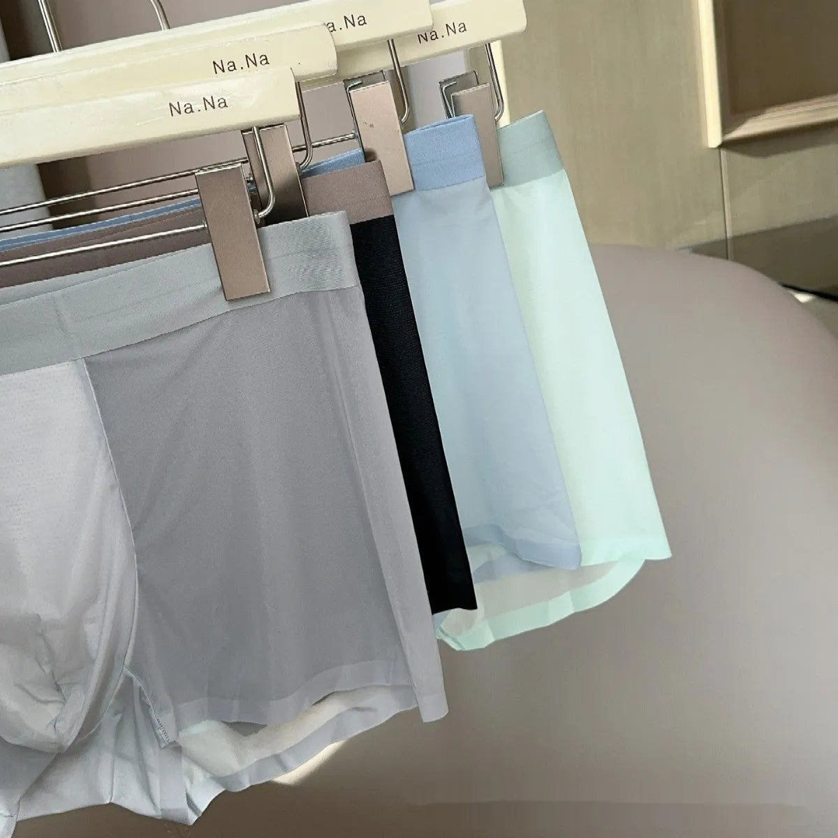 Ultra-thin antibacterial seamless men's boxers in honeycomb fabric on a colour swatch background.