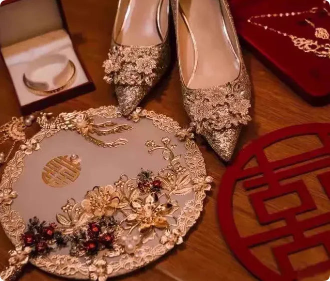 Champagne coloured women's wedding shoes with rhinestone flower pattern, pointed toe, and a fine heel.