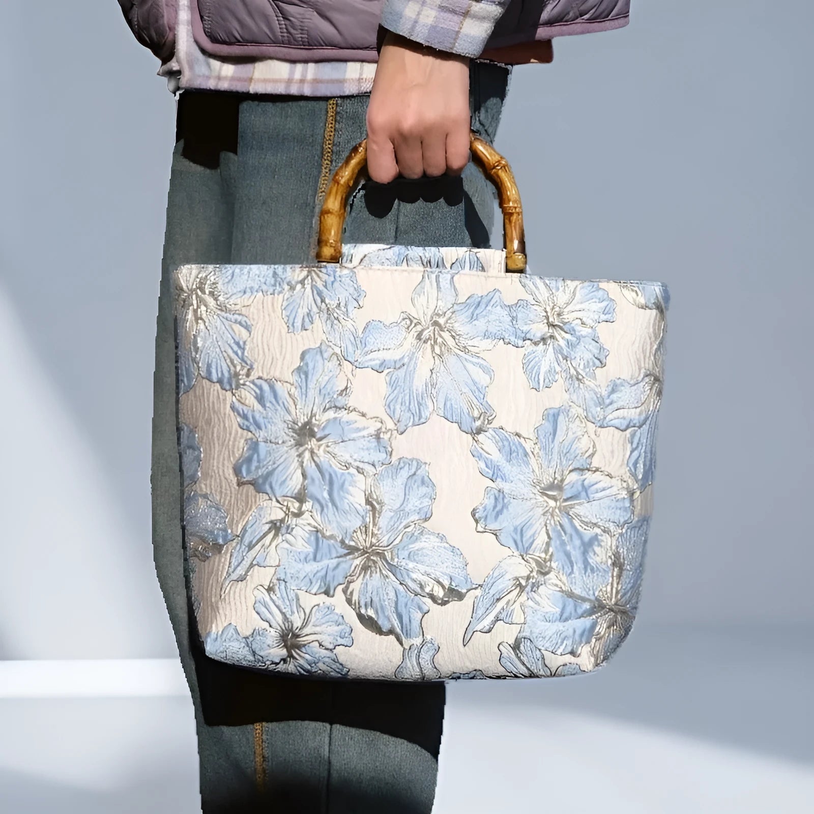 Women's light blue canvas shoulder bag with bronzing flower detail showing horizontal square shape and double straps