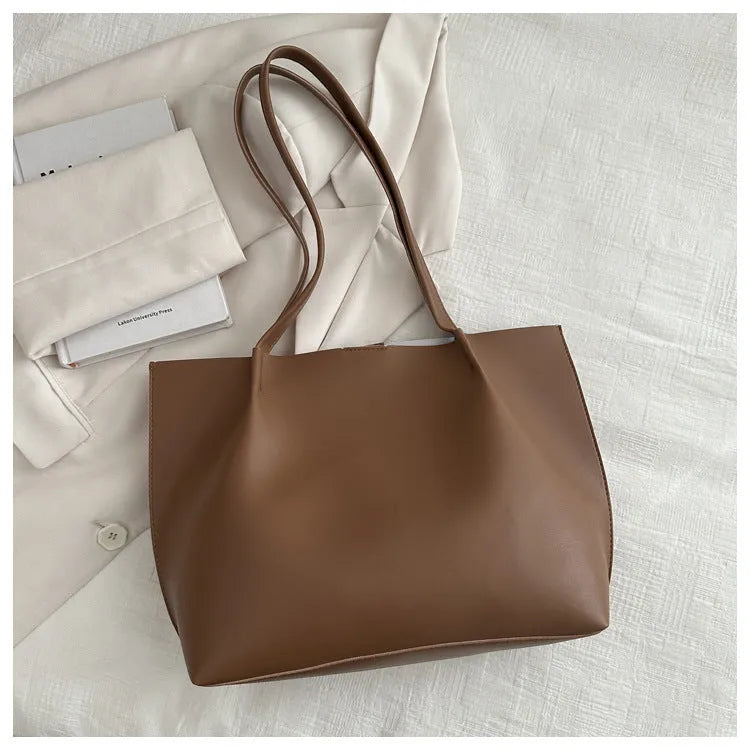 Casual messenger bag in PU leather with stitched detail, bucket shape, double shoulder straps, available in black brown coffee white