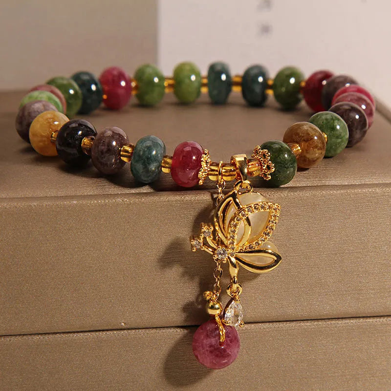 Colourful women's bracelet with a silver butterfly charm, colourful beads, and green tourmaline stones.
