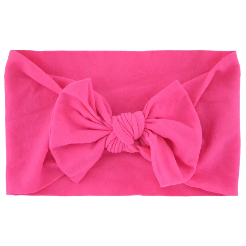 Super stretchy soft knot headband with hair bow for baby girls in one of 22 colours