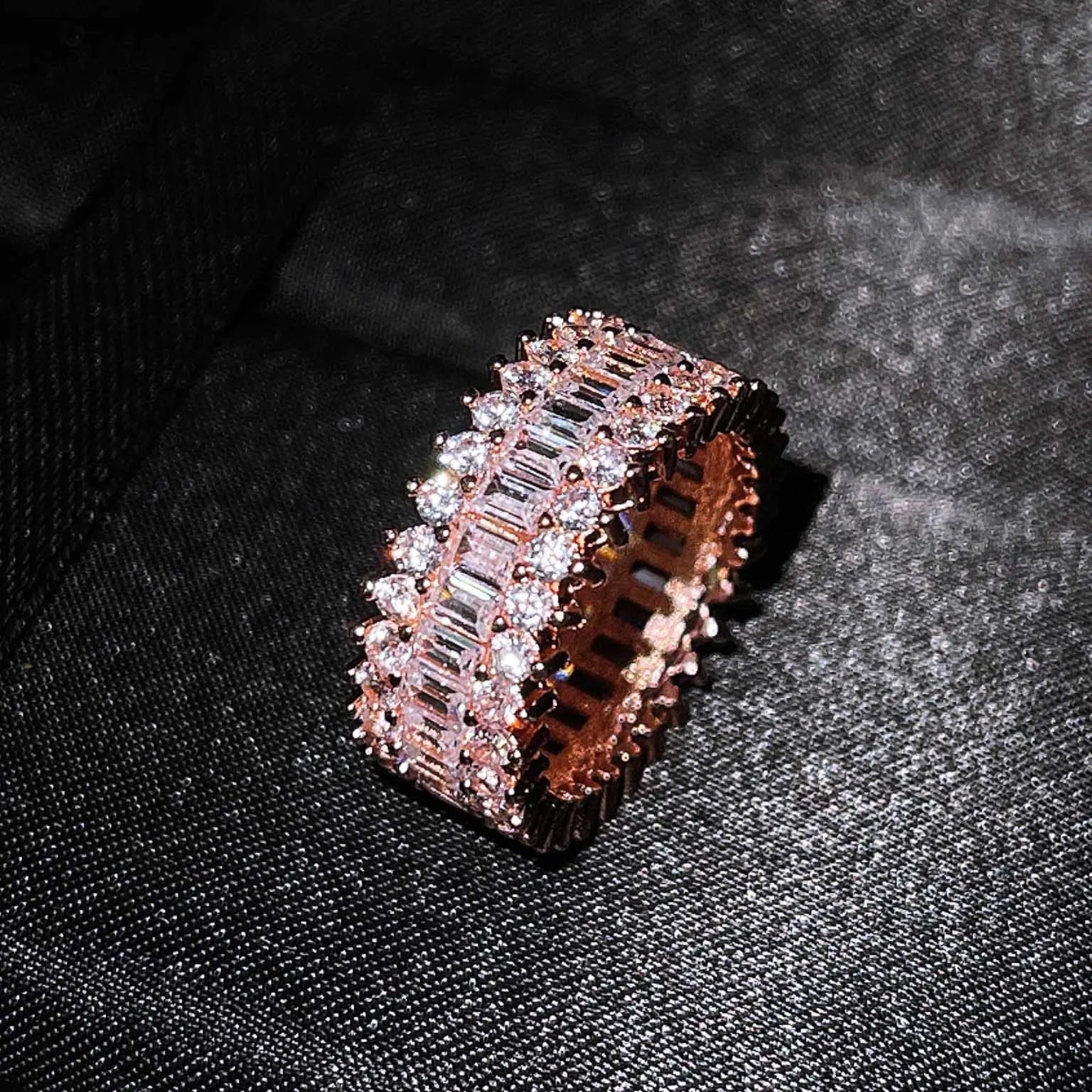 Geometric copper ring with zircon inlay in rose gold finish on neutral background