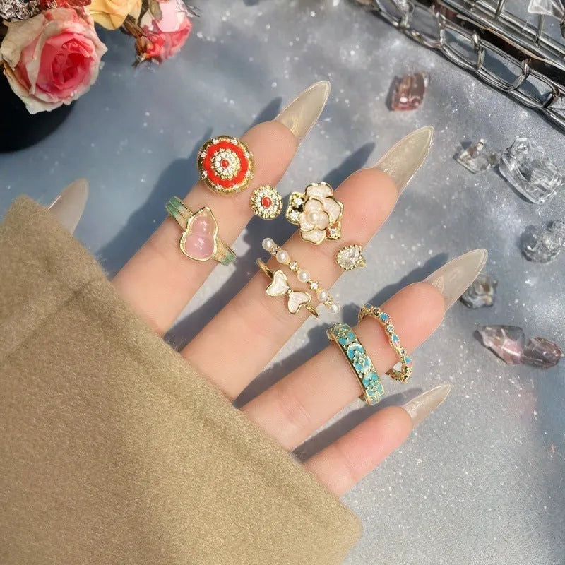 Adjustable copper ring with vintage gourd, flower, and bow design, inlaid with zircon stones.