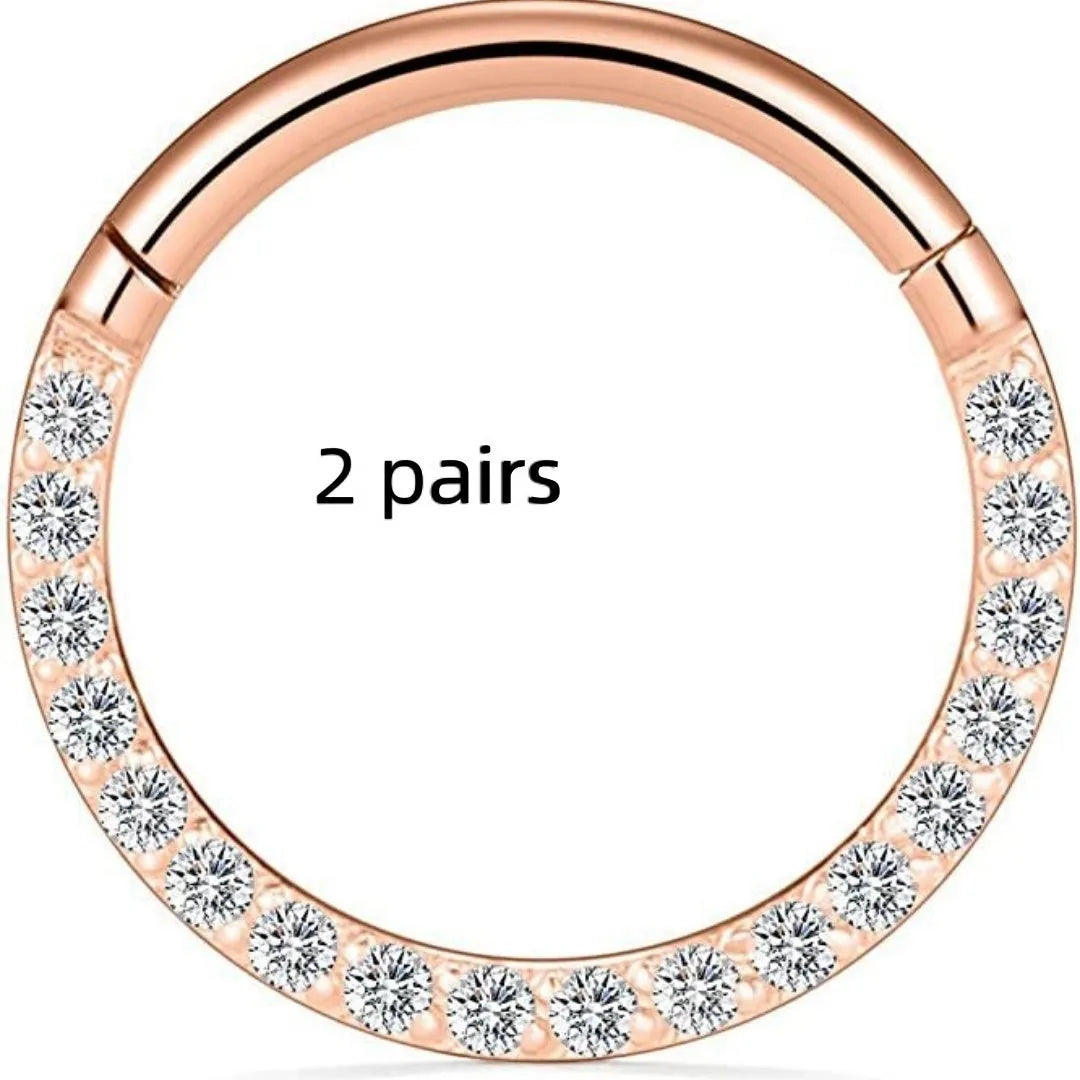 Close-up of a round, seamless stainless steel nose ring in a gold finish, showing its smooth, clasp-free design.