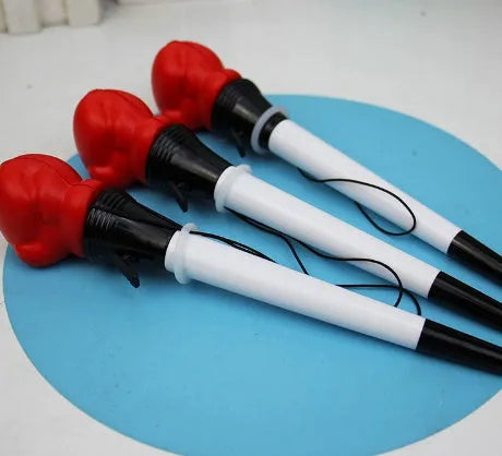 Four black pressure relief boxing press ejection pens with plug-in sleeve mechanisms on a desk.