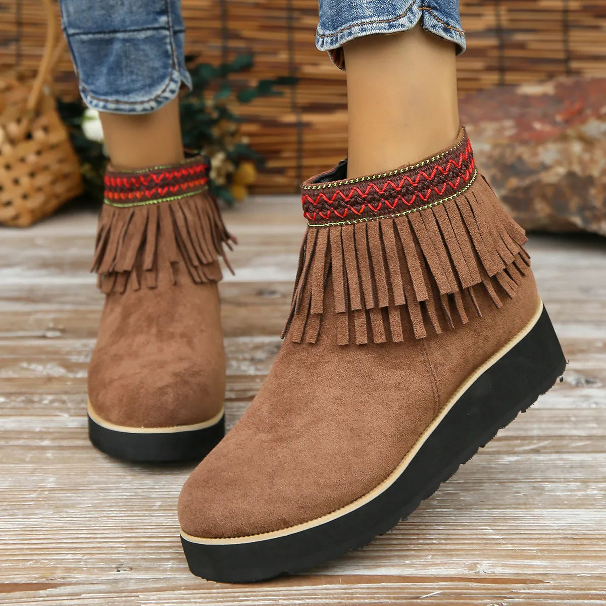 Women's suede wedge ankle boots with side zipper, thick rubber sole, and tassel detailing in dark brown colour