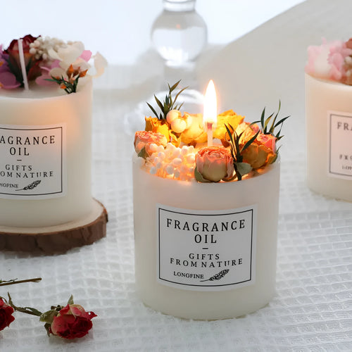 Aromatherapy candle with dried flowers on surface, shown in gift box with chip base.