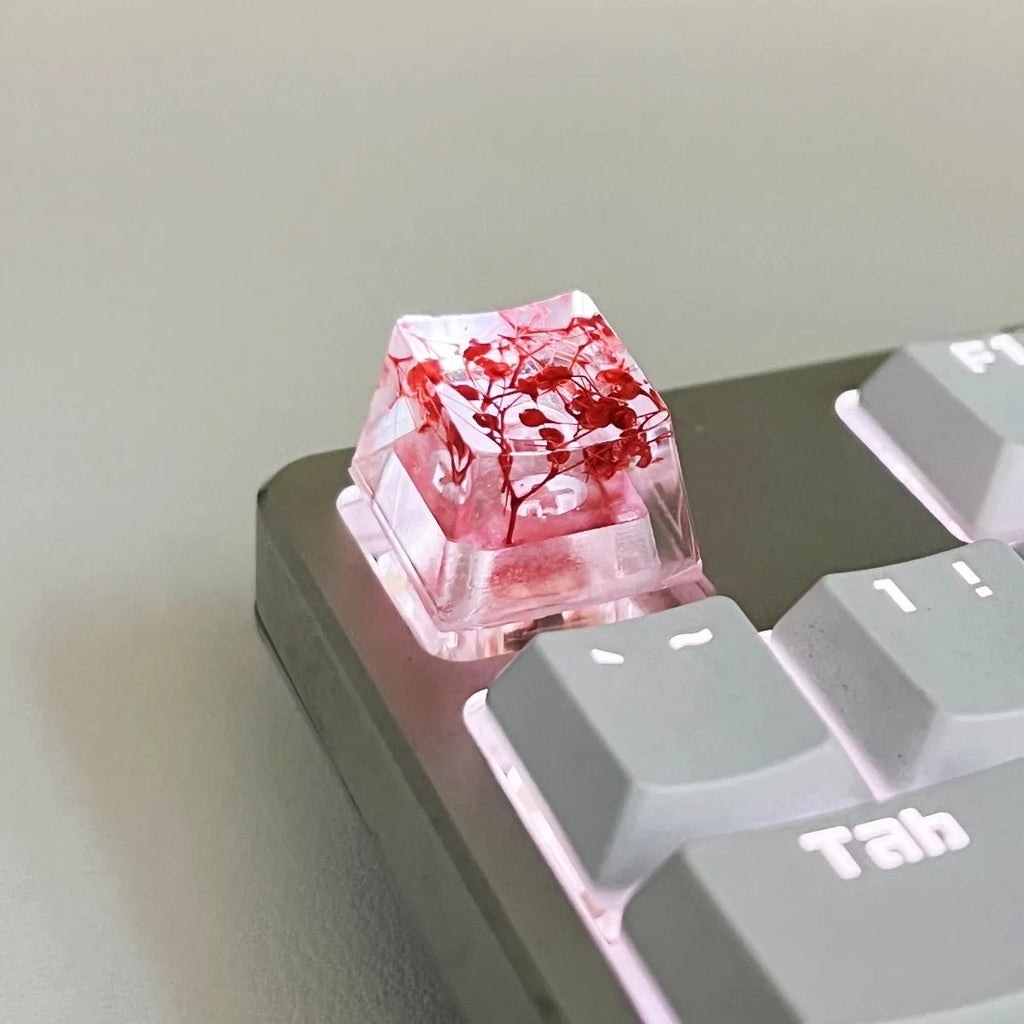 Transparent resin mechanical keyboard keycap with starry sky pattern in red, pink, green, and violet colour options