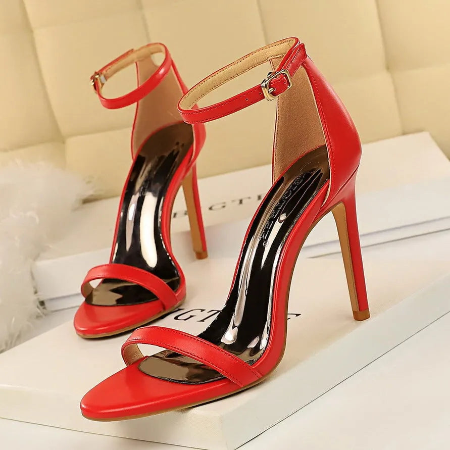 Open toe high heels with an ankle strap and buckle in a choice of six solid colours.