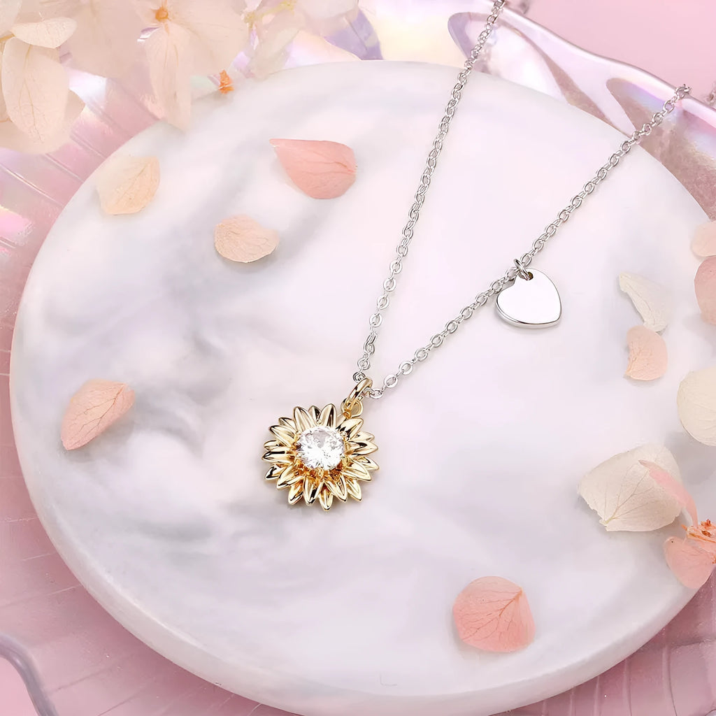 Sunflower and daisy sterling silver pendant on an adjustable cross chain necklace.