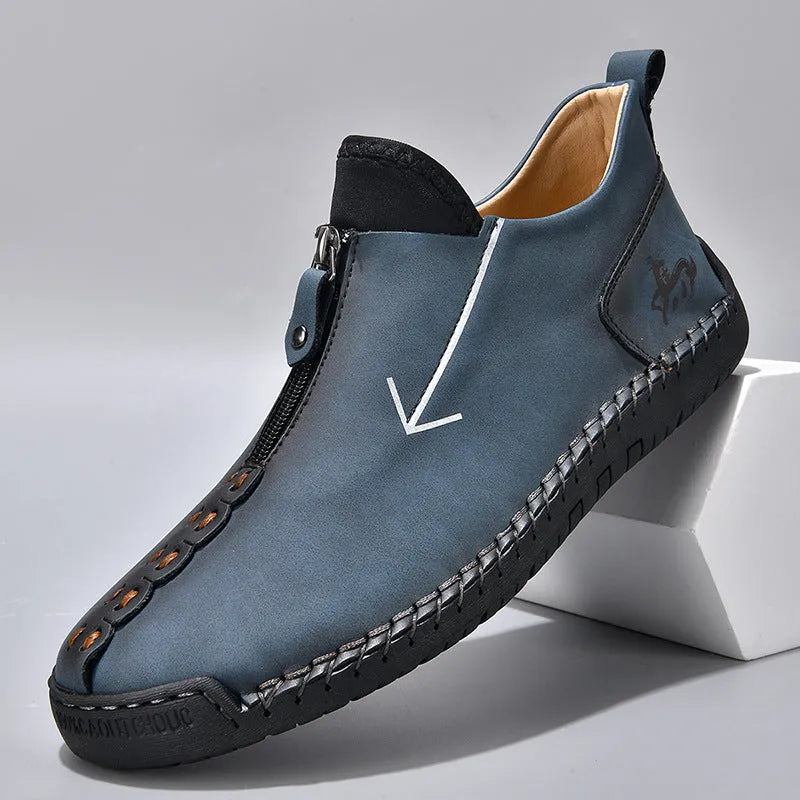 Men's black leather martin boots with a front zip, round toe, and hand-stitched seams on a rubber sole.