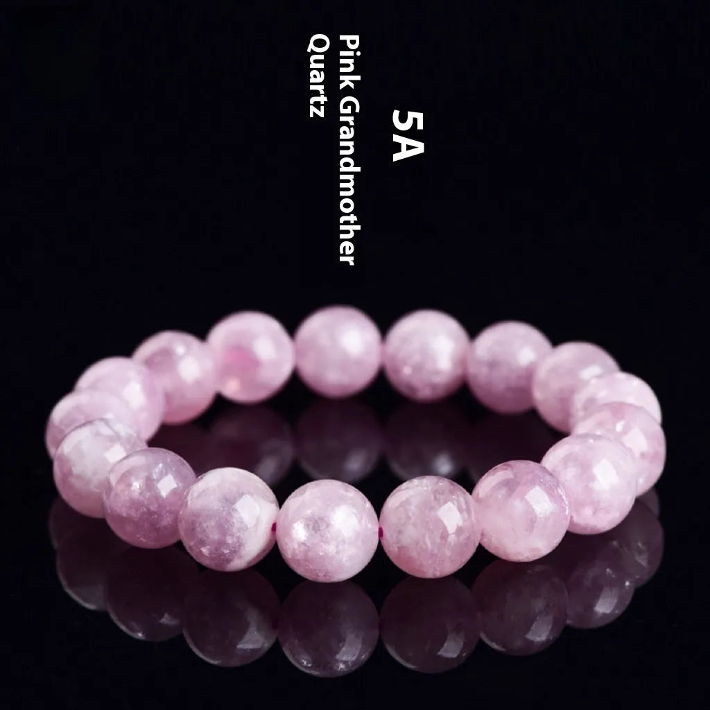 Polished geometric crystal bracelet in purple and pink hues on wrist.