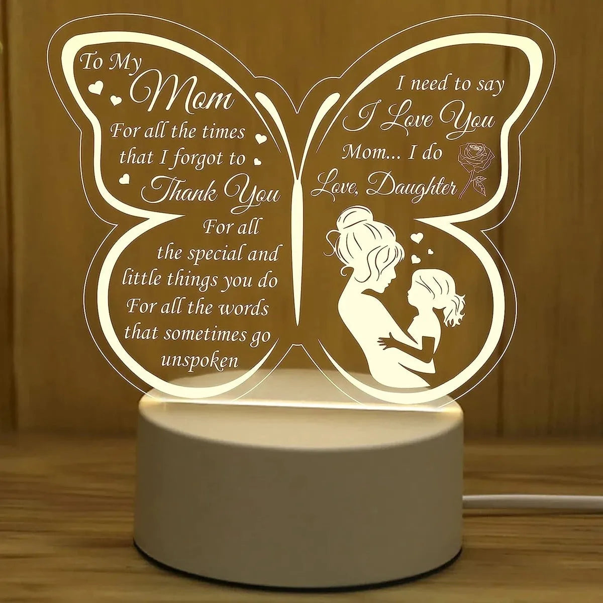 White heart-shaped acrylic table lamp with touch switch on a wooden surface.