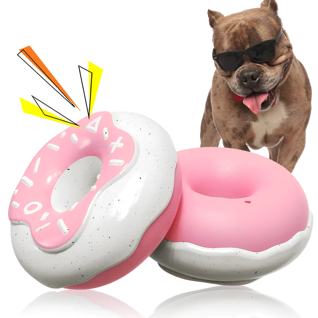 Pink TPR donut-shaped dog chew toy with raised dental cleaning nodules and squeaker inside