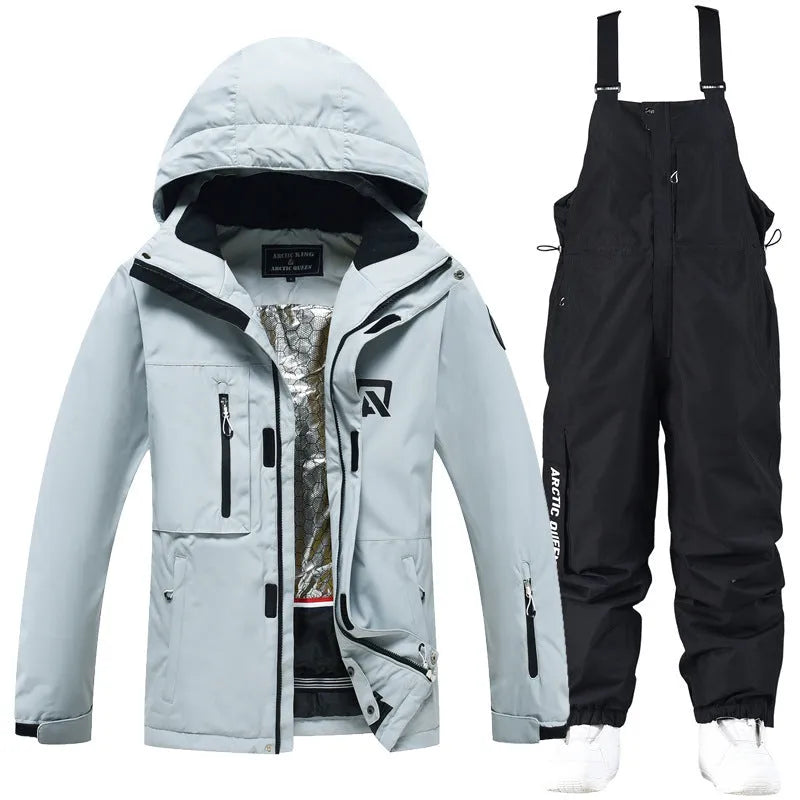 Man and woman modelling a blue and black waterproof ski suit for winter snow sports.