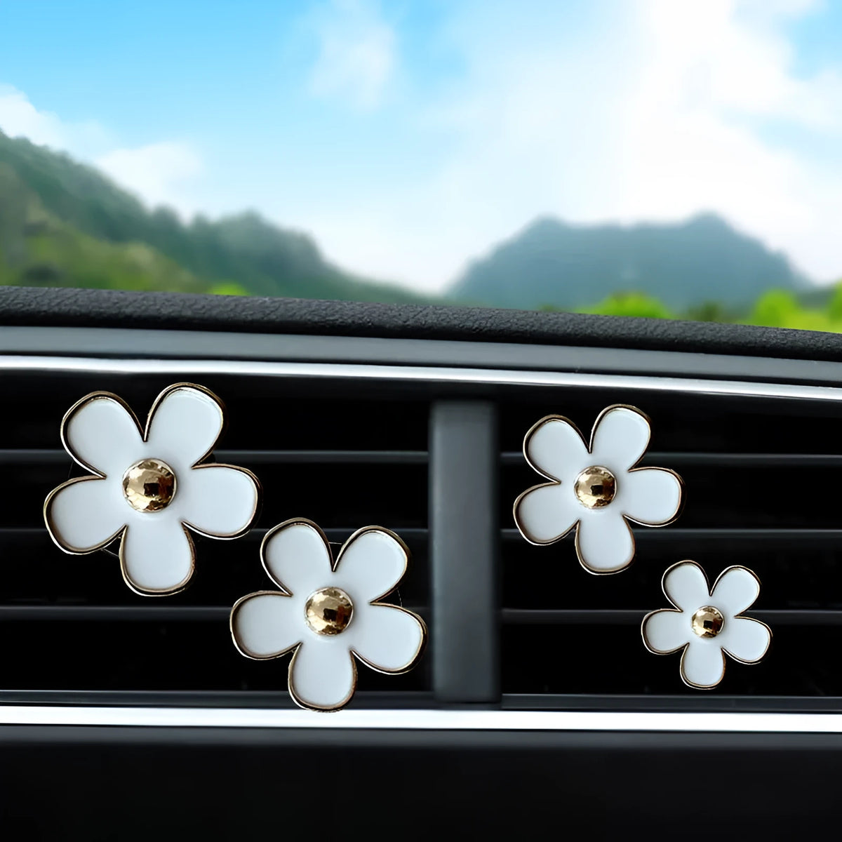 Set of four metal flower-shaped car vent aromatherapy clips in assorted colours