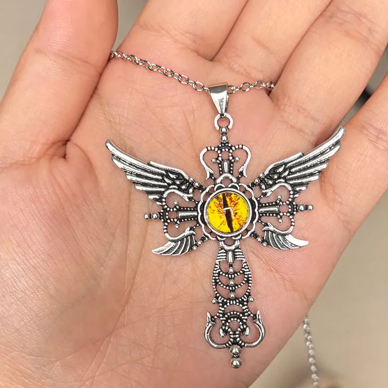 Close-up of a devil wings and cross design alloy pendant necklace on a chain, shown in a choice of colours.