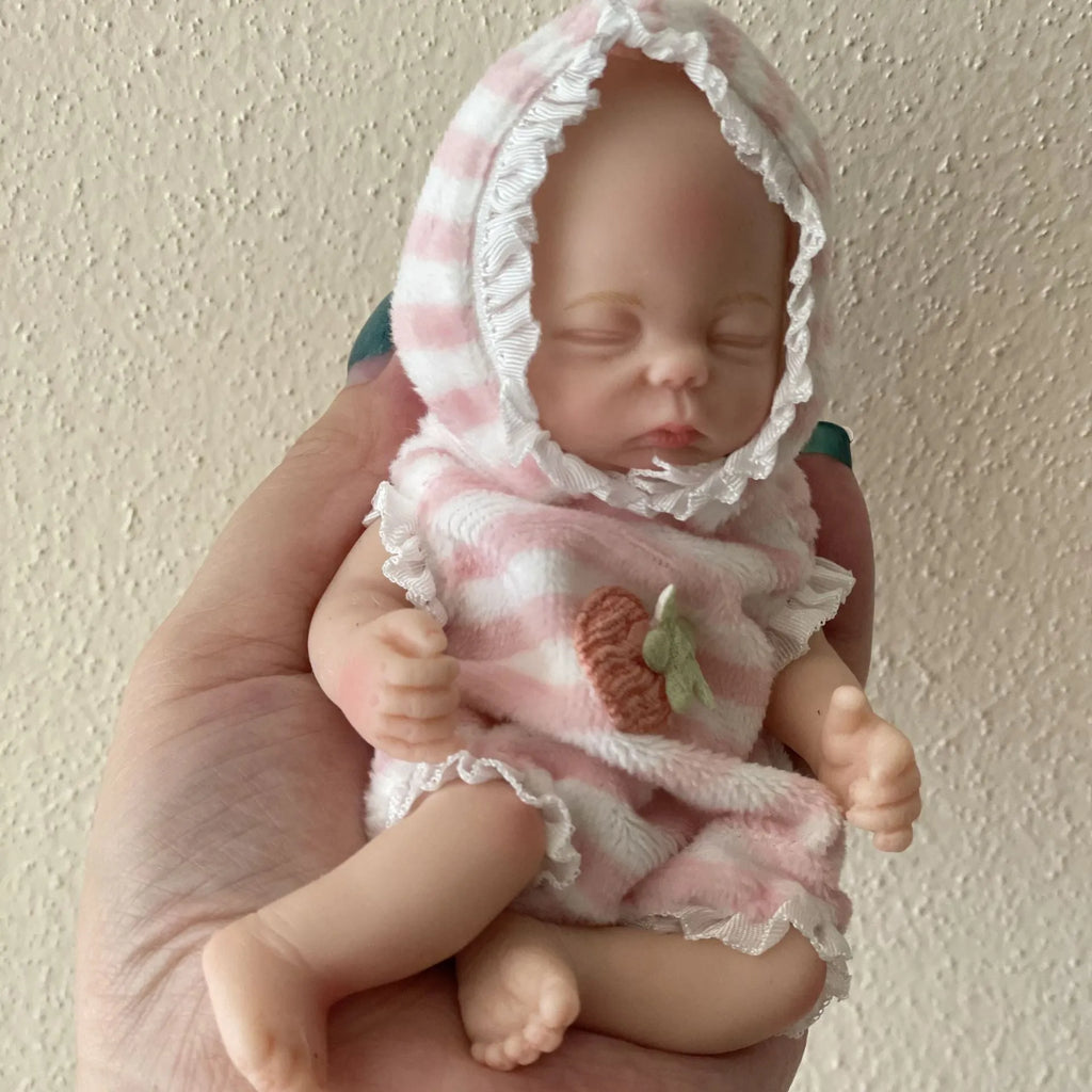 15cm solid silicone MINI palm doll simulation baby, bald girl version, on display