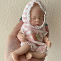 15cm solid silicone MINI palm doll simulation baby, bald girl version, on display