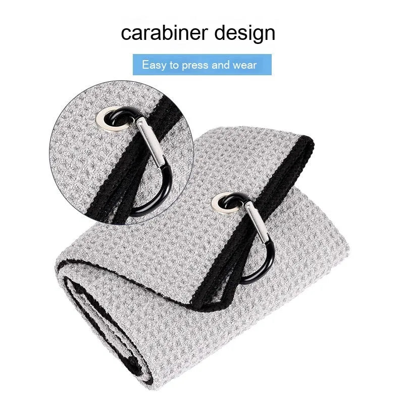 Waffle weave golf ball cleaning towel in blue, shown next to a golf ball.