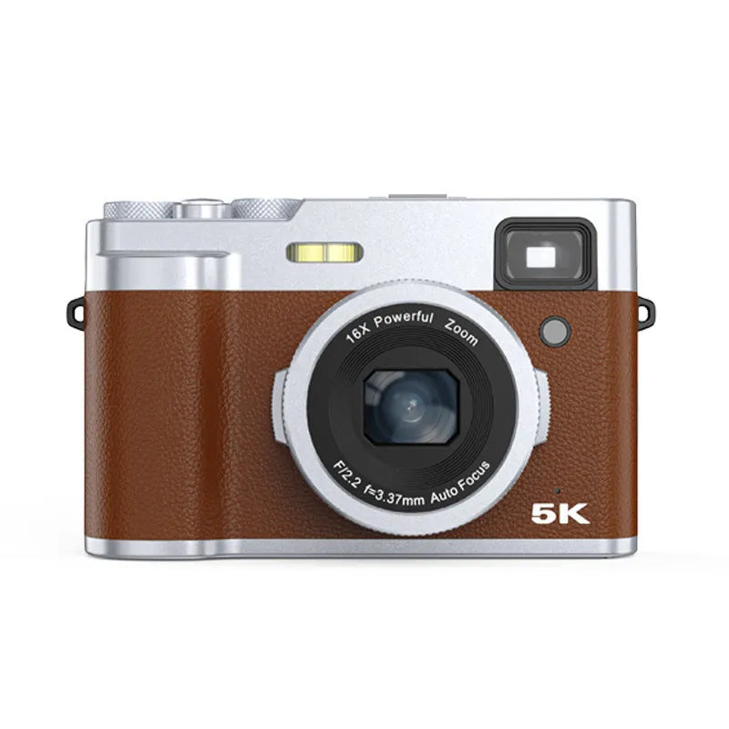 Black or brown 5K HD digital camera with dual lenses and an optical viewfinder on a table.
