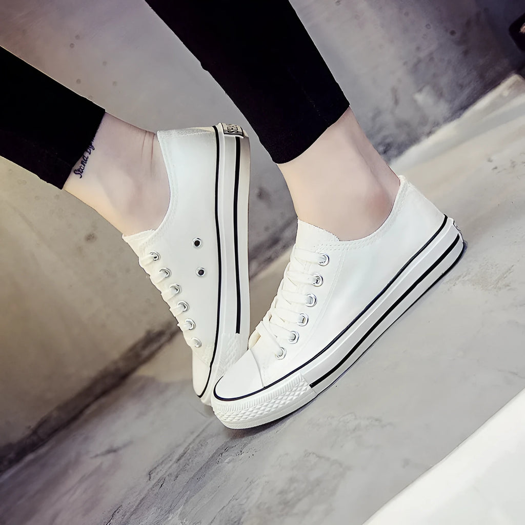 Women's solid colour canvas casual shoes shown in black, white black, white red, and all black options.