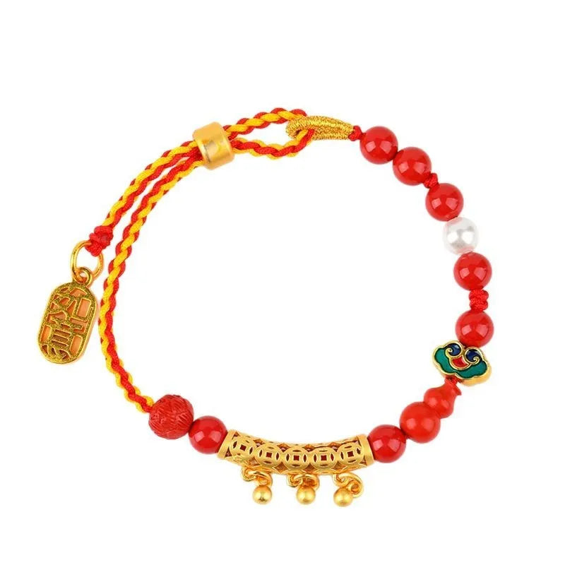 Women's hand-woven cinnabar rope bracelet with round bell charm in emperor red sand colour