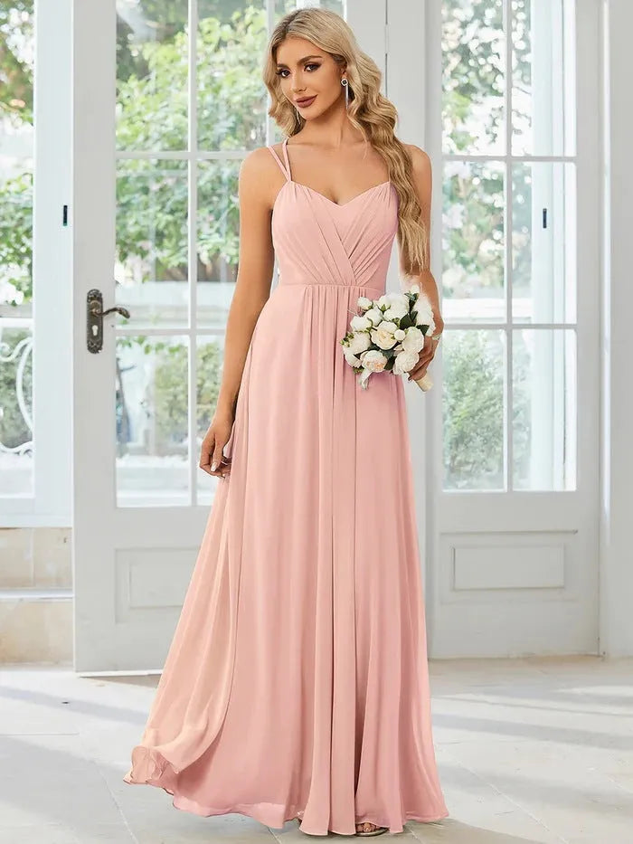 Women's sleeveless banquet dress with pleated A-line long skirt in light green, showing sling neckline.