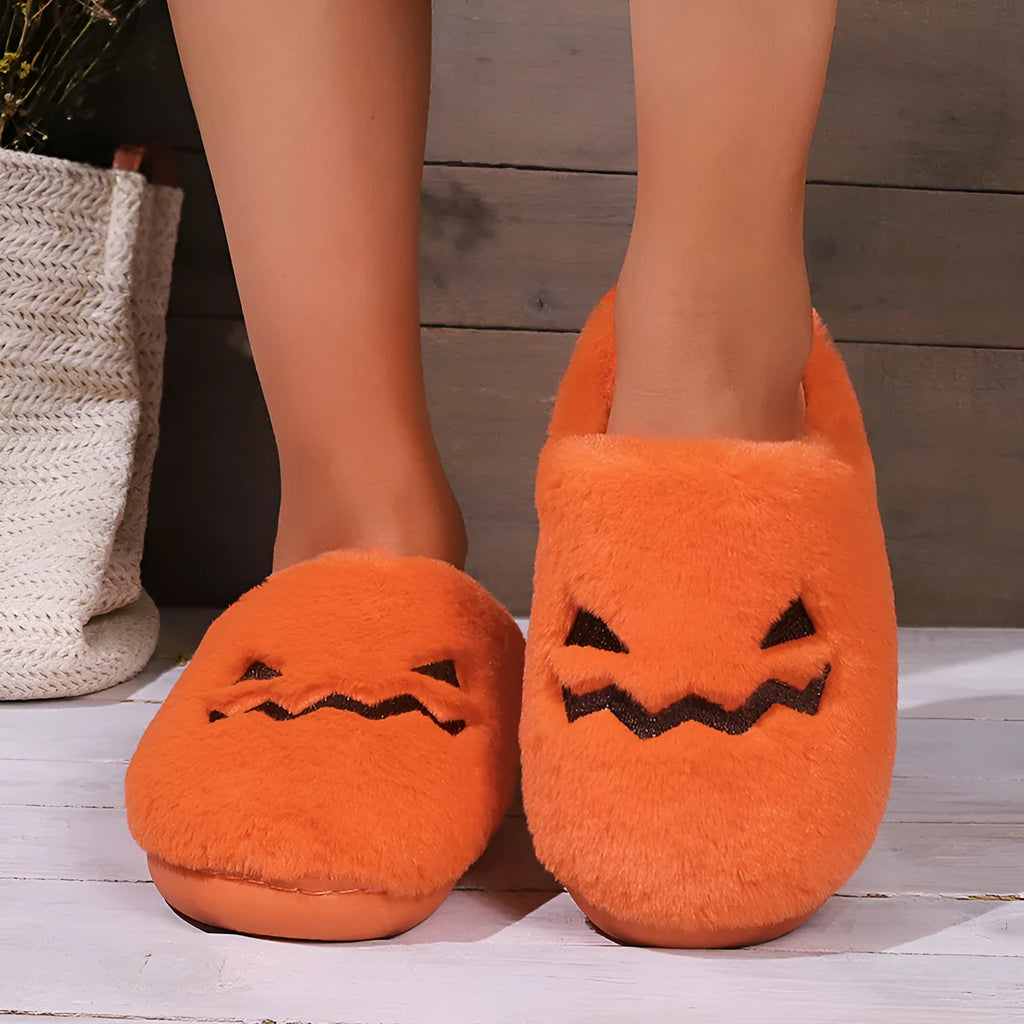 Orange pumpkin-shaped coral velvet plush slippers with a flat PVC sole.