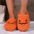 Orange pumpkin-shaped coral velvet plush slippers with a flat PVC sole.